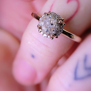 Solid gold memorial ashes ring surrounded by diamonds 