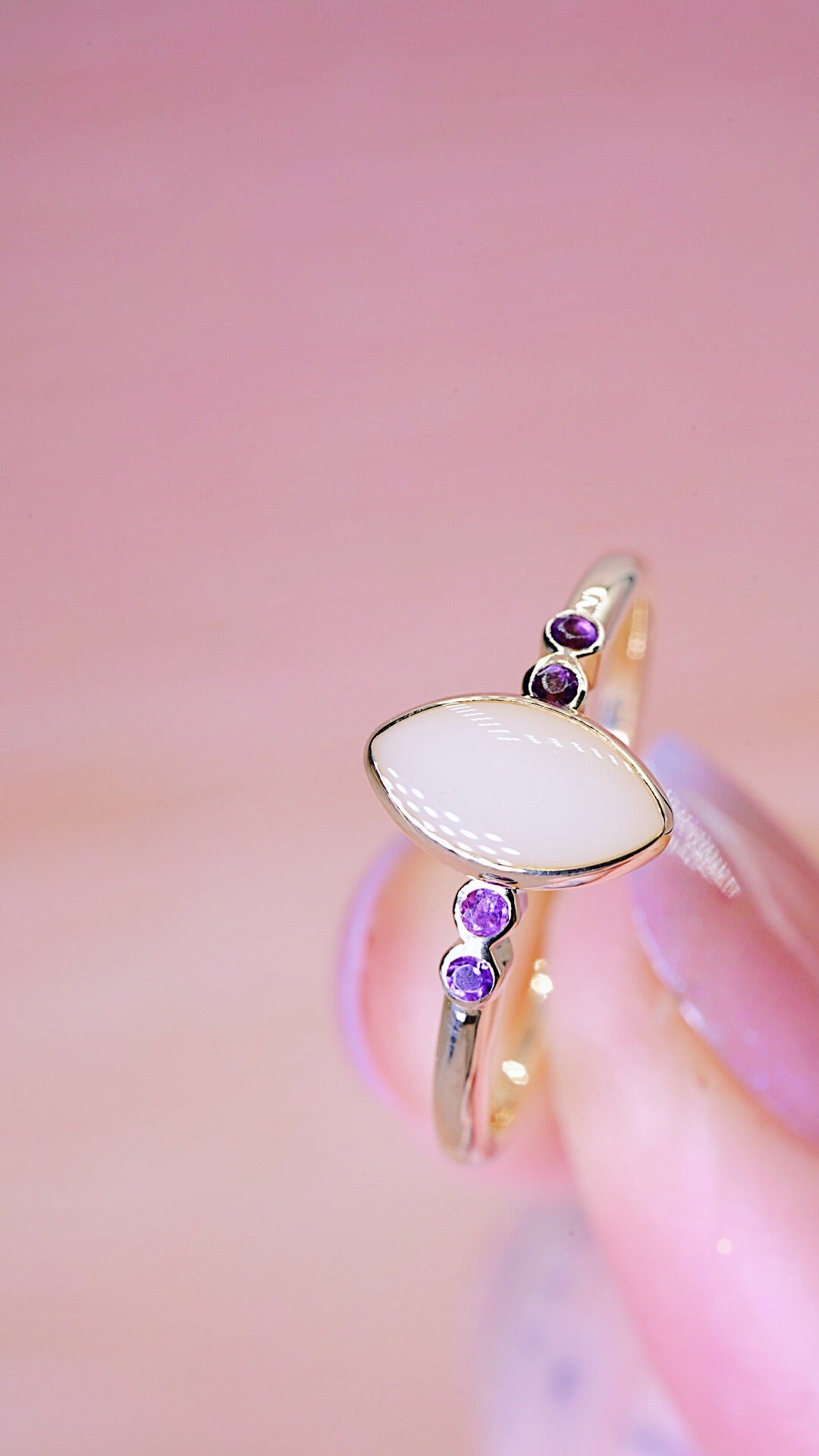 Solid gold ring with breastmilk stone centre and 2 Amethyst each side 