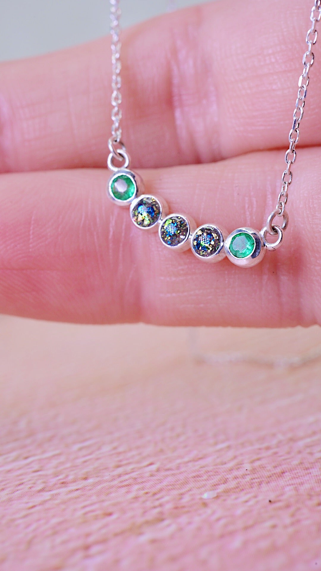 3 cremation ash stones with blue and green colour between two Emerald stones 