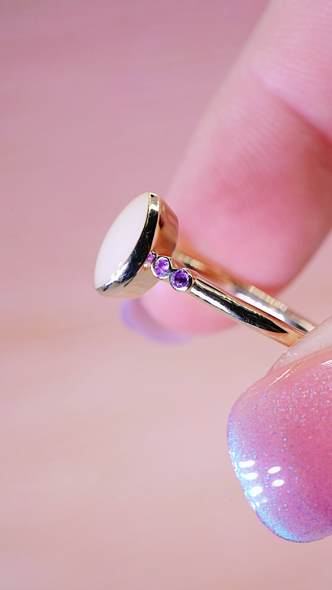 Solid gold ring with breastmilk stone centre and 2 Amethyst each side 