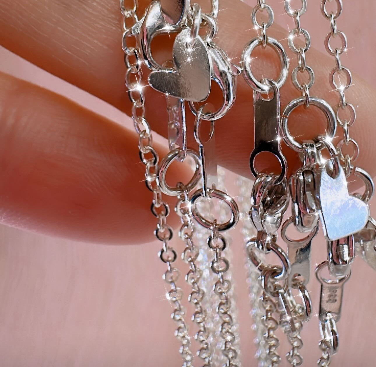 little silver hearts attached to silver chains as a keepsake pendant