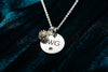 engraved disk with cremation ashes charm on chain