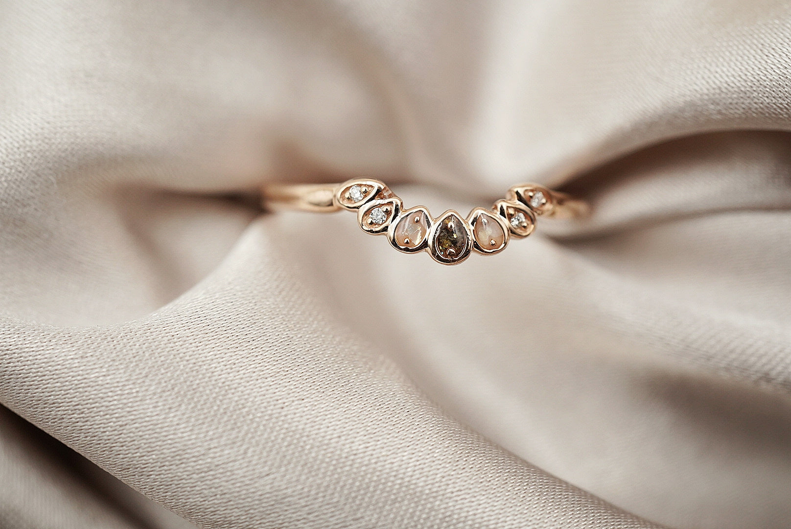 ring band with 3 inclusion stones and 4 diamonds